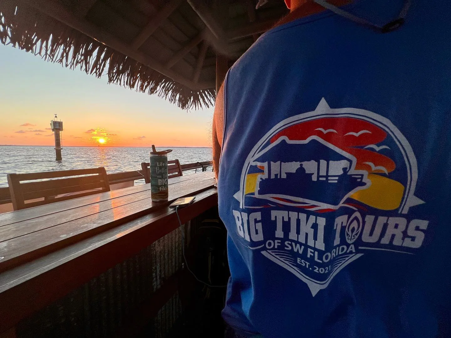 Big Tiki Tours branded shirt beside a Southwest Florida sunset