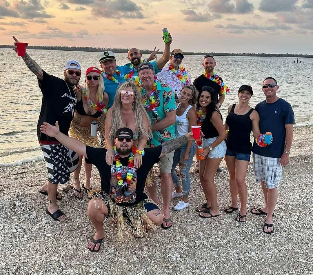 Friends gathered on a quiet Southwest Florida beach during a private island excursion