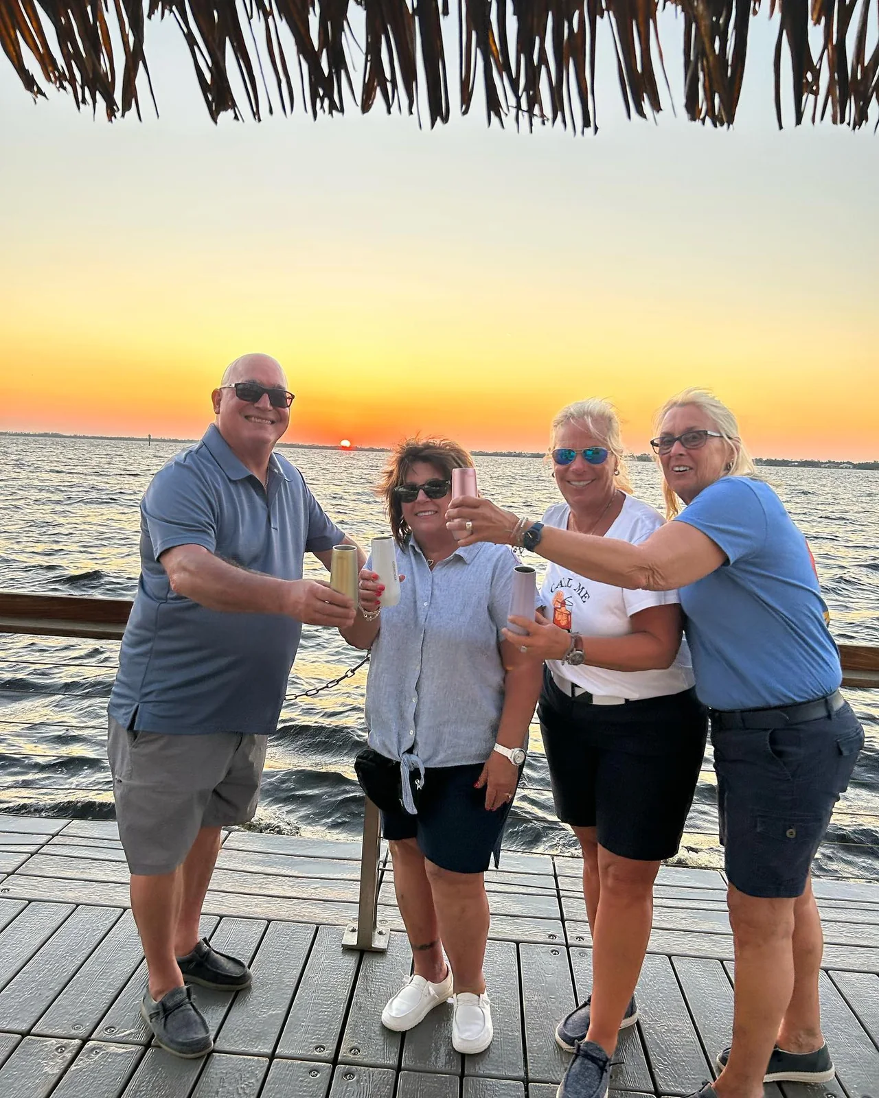 Friends raising a toast aboard Big Tiki Tours at a Southwest Florida sunset