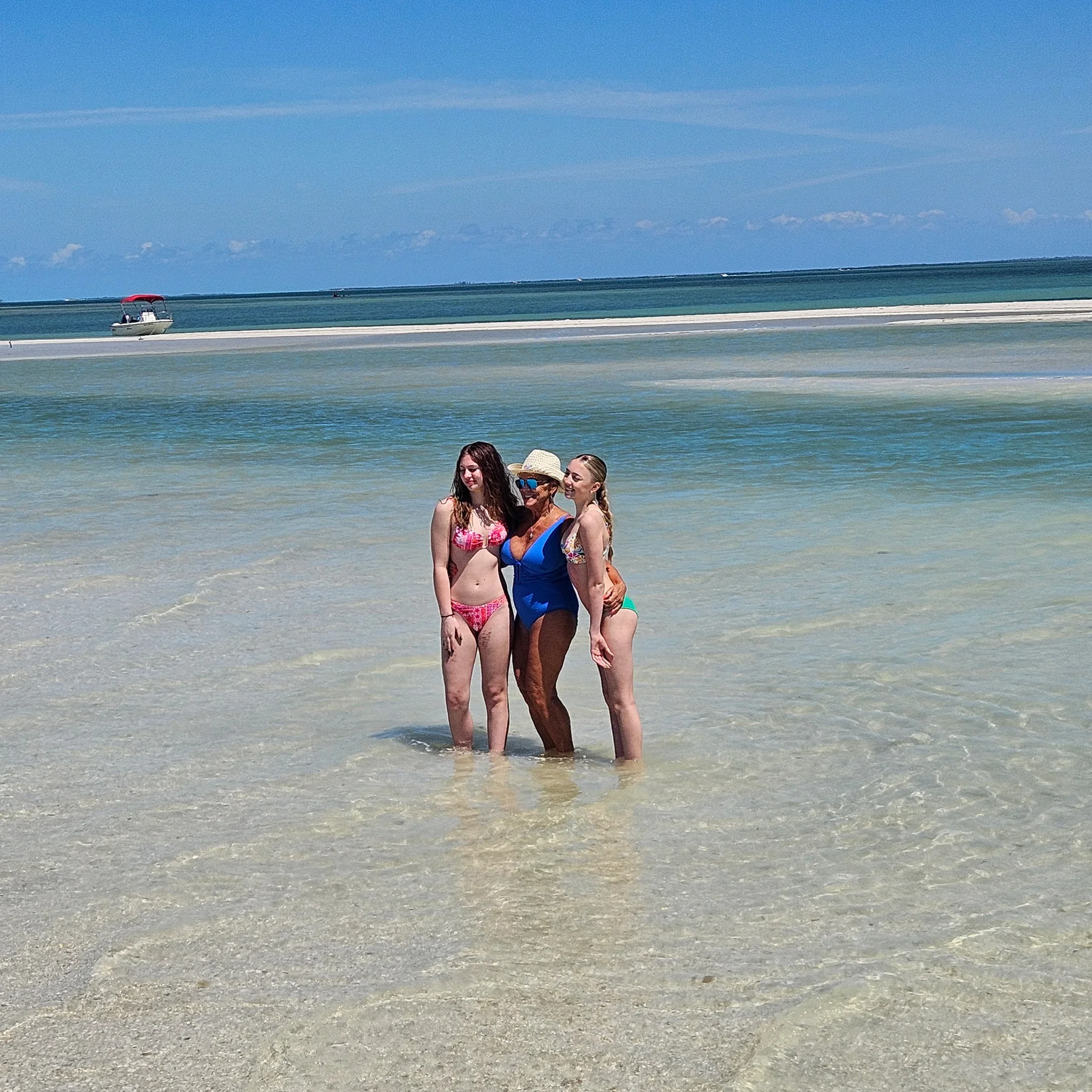 Family standing in clear shallow water during a Southwest Florida island excursion