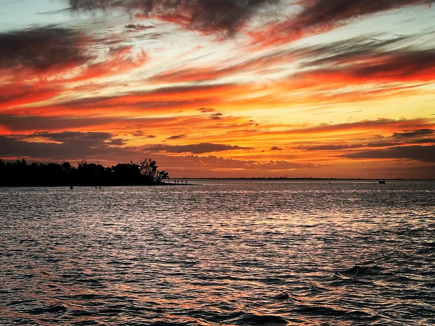 Vivid orange sunset over Southwest Florida water
