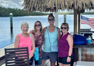 Tiki boat cruising Cape Coral canals near waterfront homes