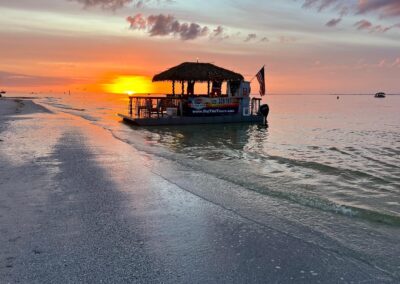 Tiki boat charter near a sandbar for a swim break