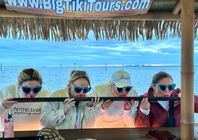 Guests enjoying drinks on a tiki boat tour