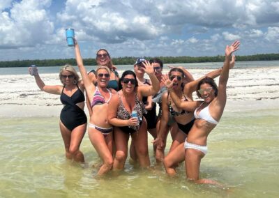 Guests cheering drinks on a tiki boat tour